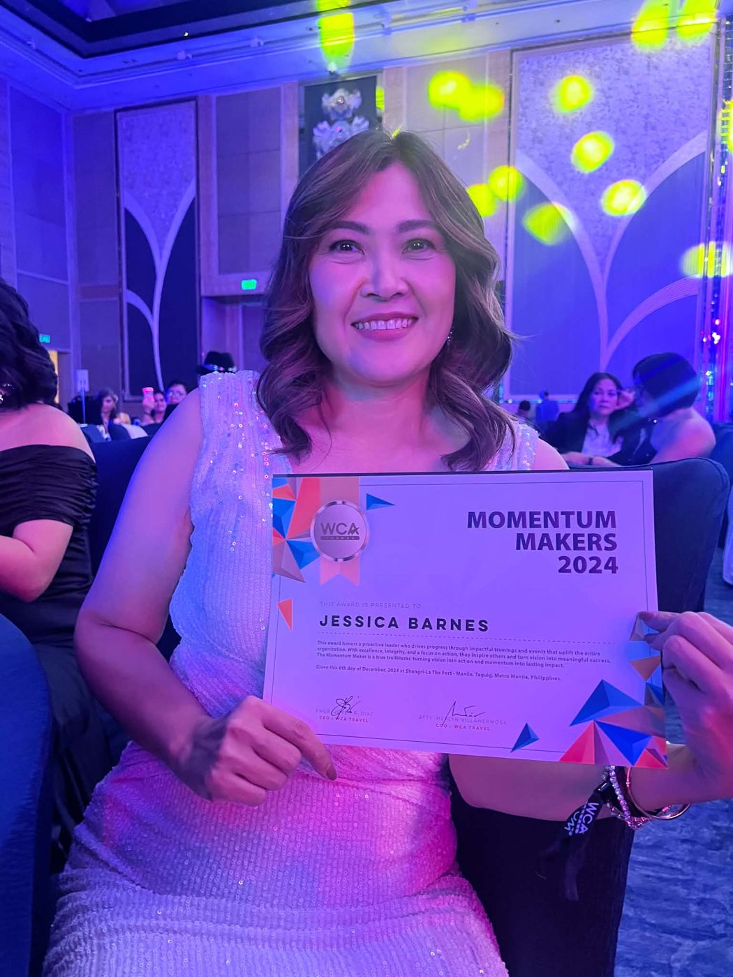 Jhec Barnes holding her Momentum Makers 2024 certificate